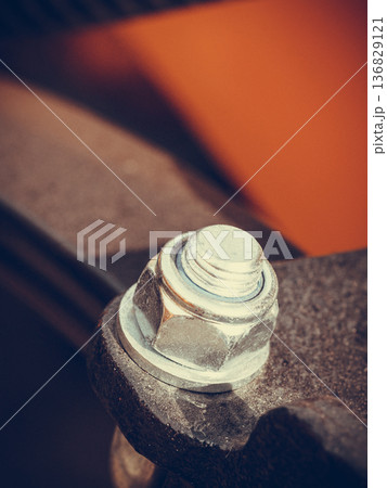 Detailed closeup of screw on indrustrial machinery Detailed closeup of screw on indrustrial machinery 136829121