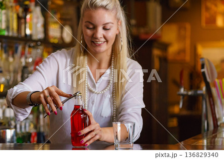 Woman working at the bar counter Woman working at the bar counter 136829340