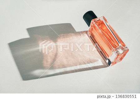 Perfume bottle presenting luxury fragrance with sunlit shadow and reflection Perfume bottle presenting luxury fragrance with sunlit shadow and reflection 136830551