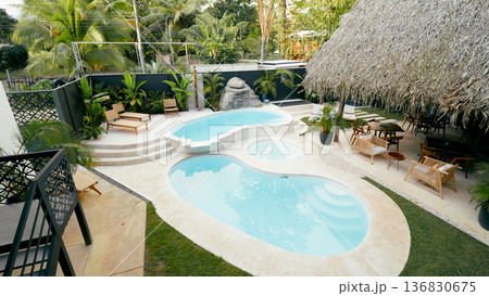 Resort swimming pool tropical lush backyard oasis Resort swimming pool tropical lush backyard oasis 136830675