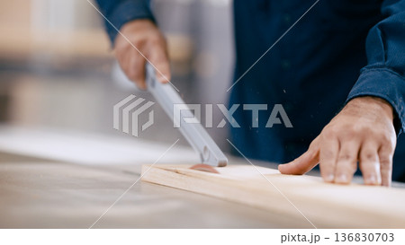 Carpenter cutting wood plank on table saw in workshop Carpenter cutting wood plank on table saw in workshop 136830703