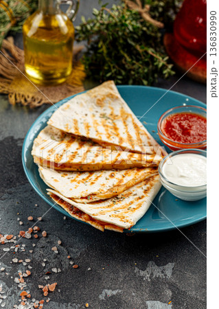 Grilled chicken quesadilla with sauces 136830990
