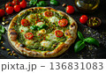 Innovative matcha flavored pizza with sliced tomatoes on dramatic dark surface, contemporary culinary experiment 136831083