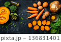Avocado, salmon, carrots, eggs and pumpkin arranged on black background, vitamin A rich foods concept 136831401