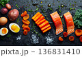 Flat lay composition of vitamin A ingredients on black textured background, healthy lifestyle concept 136831410
