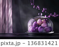 Purple and pink dyed Easter eggs under glass dome on dark background, dramatic festive styling 136831421