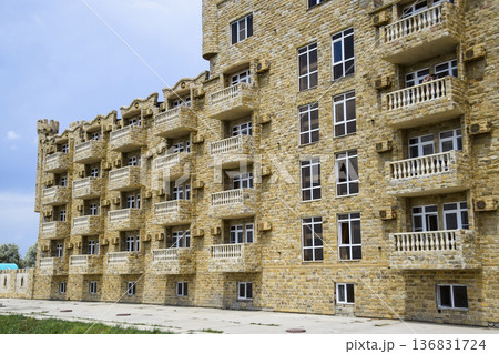 The hotel building, covered with decorative stone. Multi-storey hotel with a decorative trim, which is called Dagestani stone The hotel building, covered with decorative stone. Multi-storey hotel with a decorative trim, which is called Dagestani stone 136831724