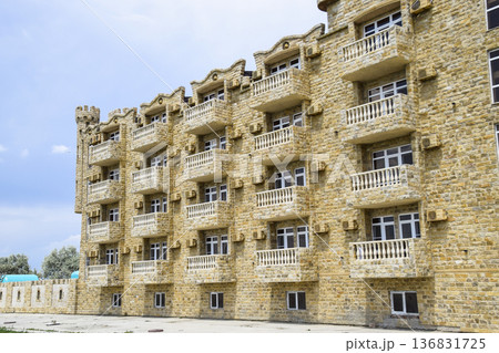 The hotel building, covered with decorative stone. Multi-storey hotel with a decorative trim, which is called Dagestani stone The hotel building, covered with decorative stone. Multi-storey hotel with a decorative trim, which is called Dagestani stone 136831725