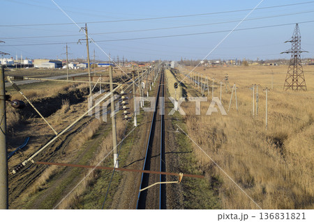 Plot railway. Top view on the rails. High-voltage power lines for electric trains Plot railway. Top view on the rails. High-voltage power lines for electric trains 136831821