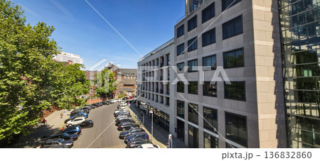 Urban street view with modern buildings and parked cars Urban street view with modern buildings and parked cars 136832860
