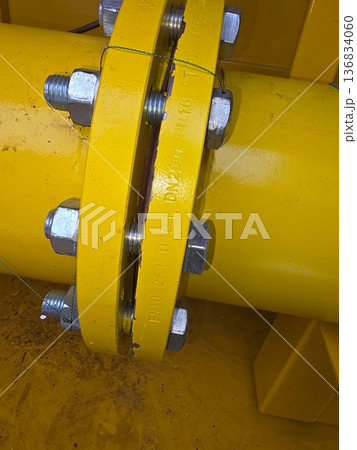 Close View of Yellow Gas Pipe With Flange Connection and Bolts on Construction Site 136834060