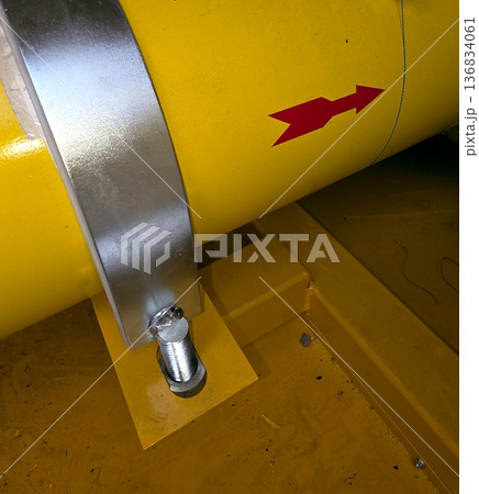 Yellow Gas Pipe With Red Arrow Pointing in Direction of Flow in Industrial Area Yellow Gas Pipe With Red Arrow Pointing in Direction of Flow in Industrial Area 136834061