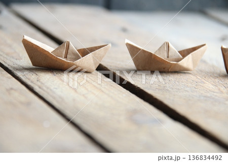 Paper boats on a vintage background. Paper boats on a vintage background. 136834492
