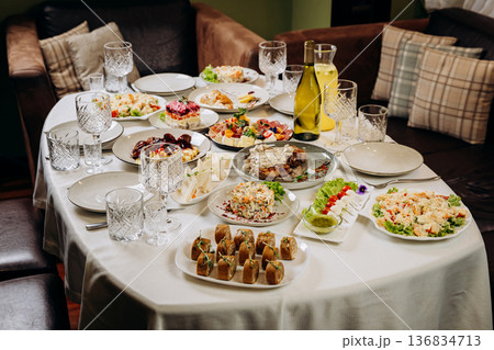 Festive banquet table with assorted dishes prepared for celebration dinner 136834713