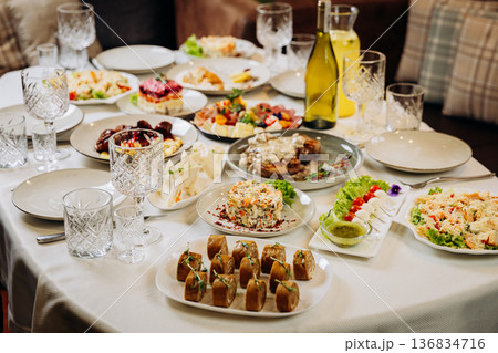 Festive banquet table with assorted gourmet dishes and appetizers ready for celebration 136834716