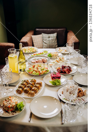 Festive banquet table with assorted dishes prepared for celebration dinner 136834718