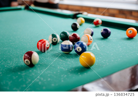 Colorful billiard balls on pool table ready for game in leisure entertainment club 136834725