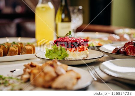 Layered herring Shuba salad with beetroot and mayonnaise on festive table 136834728