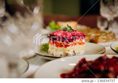 Layered herring Shuba salad with beetroot and mayonnaise on festive table 136834737