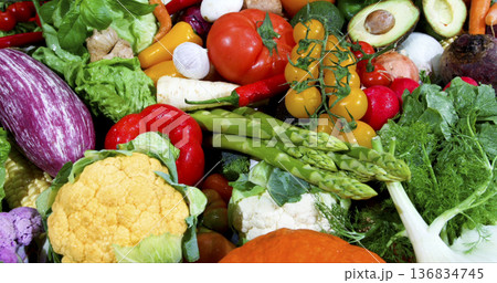 Fresh vegetables on display at a market showing a variety of colors and shapes during a sunny afternoon Fresh vegetables on display at a market showing a variety of colors and shapes during a sunny afternoon 136834745