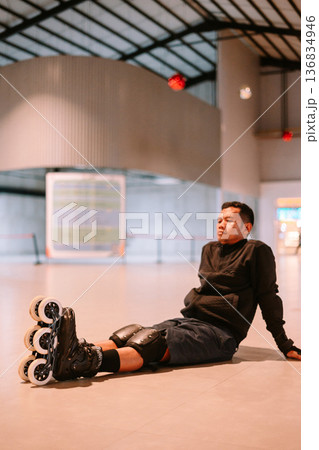 Inline Skater Resting on Floor After Sport Session Inline Skater Resting on Floor After Sport Session 136834946