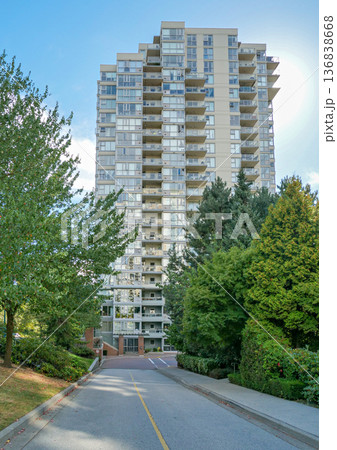 Asphalt driveway leading to a nice residential building 136838668