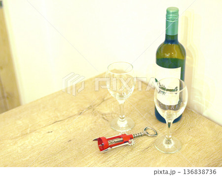 Wine bottle with glasses and corkscrew on wooden table Wine bottle with glasses and corkscrew on wooden table 136838736