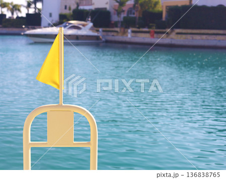 Yellow Flag At Quiet Marina By Water Yellow Flag At Quiet Marina By Water 136838765