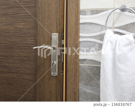 Wooden Door with Towel in Bathroom 136838767