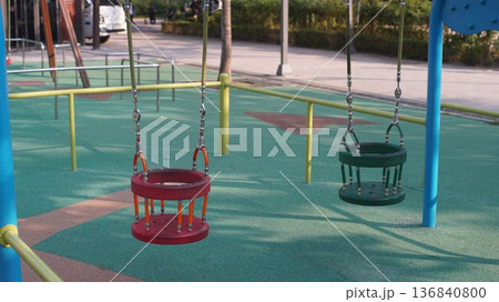 Toddler swing at public park playground Toddler swing at public park playground 136840800