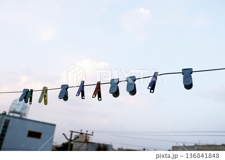 Colorful Clothespins Hanging on Laundry Line Outdoors 136841848