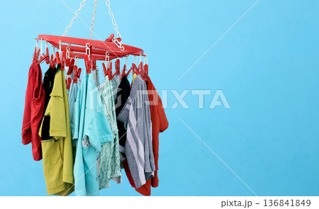 Colorful baby Clothes Hanging on Plastic Clip Hanger Colorful baby Clothes Hanging on Plastic Clip Hanger 136841849