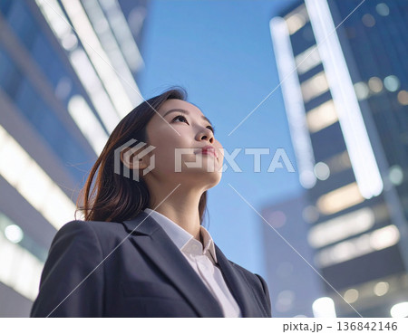 空を見上げるスーツ姿の女性、未来へのステップ 136842146