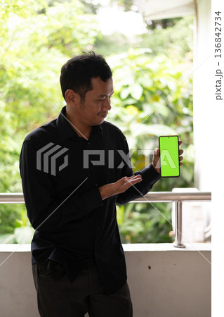 asian man looking at tablet 136842734