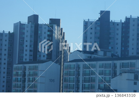 Hazy Korean City Skyline with Mountains and High Rise Apartments 136843310