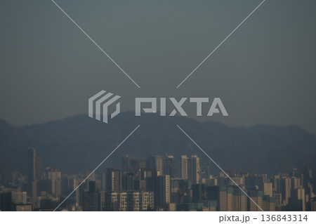 Hazy Korean City Skyline with Mountains and High Rise Apartments 136843314