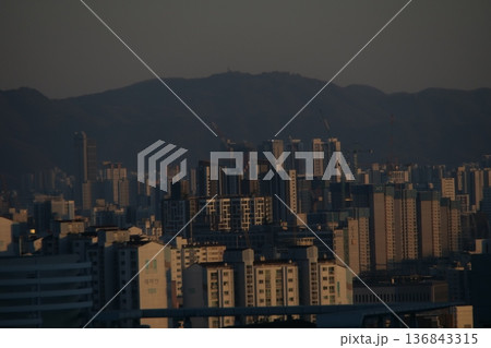 Hazy Korean City Skyline with Mountains and High Rise Apartments 136843315