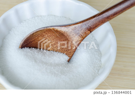 Minimalist sugar composition with spoon and bowl emphasizing refined sugar intake and healthy lifestyle decisions. Minimalist sugar composition with spoon and bowl emphasizing refined sugar intake and healthy lifestyle decisions. 136844001