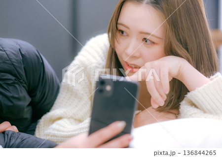 自宅でスマートフォンを見る20代日本人女性 136844265