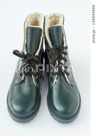 Pair of Green Leather Winter Boots on white background. New shoes Pair of Green Leather Winter Boots on white background. New shoes 136844666