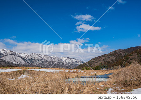 浅春の知内川と残雪の野坂山地　滋賀県高島市マキノ町 136845356