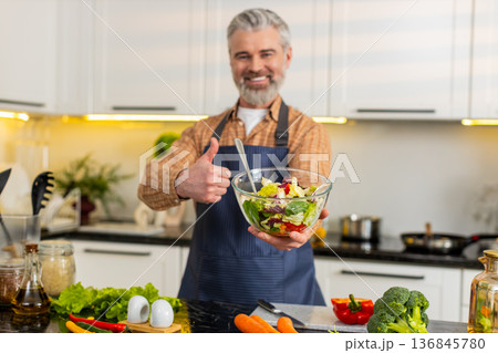 Middle-aged man presenting vegetable salad bowl in home kitchen for healthy diet meal prep guide pro Middle-aged man presenting vegetable salad bowl in home kitchen for healthy diet meal prep guide pro 136845780