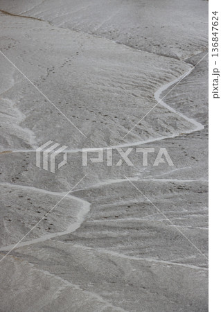Water meandering through river mud at low tide Water meandering through river mud at low tide 136847624