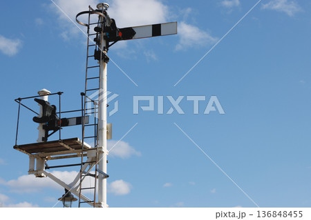 Pair of old-fashioned railway semaphore signals and blue sky background 136848455