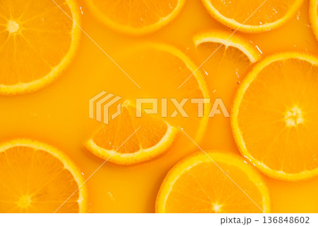 Orange slices swimming in fresh orange juice, horizontal macro. Orange slices swimming in fresh orange juice, horizontal macro. 136848602