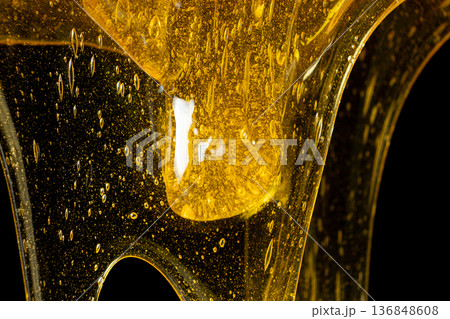 Macro Texture Of Liquid Fresh Honey On Black Background. Macro Texture Of Liquid Fresh Honey On Black Background. 136848608