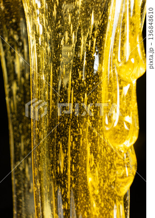 Natural honey mass with air bubbles macro. 136848610