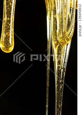 Macro Texture Of Liquid Fresh Honey On Black Background. 136848612