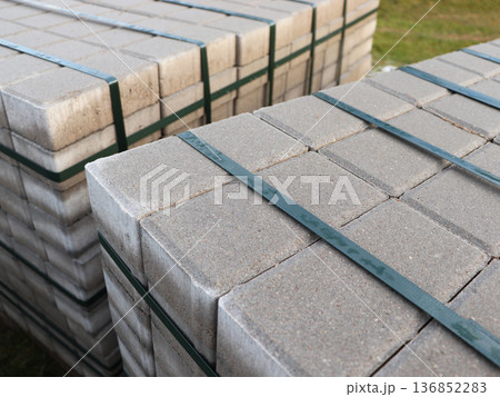 Stack of paving stone on construction site. Bricks for paving stones stacked in stacks	 136852283