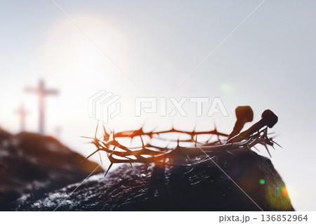 The cross and crown of thorns symbolizing the suffering and death of Jesus Christ, and the backdrop of the Passion Week on Calvary Hill. 136852964